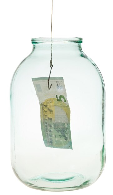 Photo catching the last euro banknote from glass jar