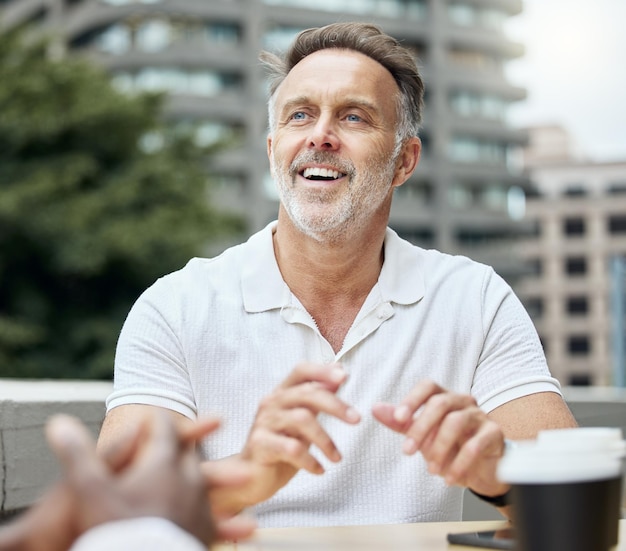 Catching up casually with his colleagues Shot of a mature businessman having a break with his colleagues outside an office