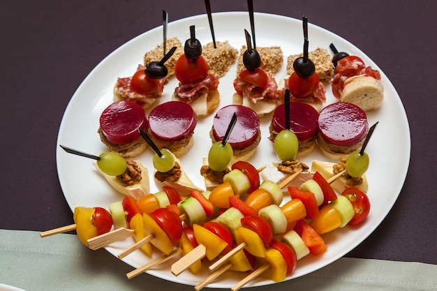 Catering food for holidays and events Various cold snacks on croissants for a buffet table