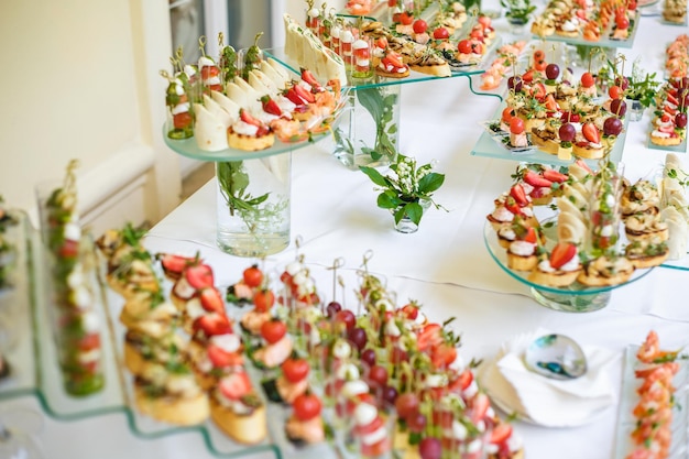 Catering offsite food buffet table with various canapes\
sandwiches hamburgers and snacks