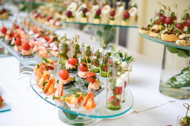 Catering offsite food buffet table with various canapes\
sandwiches hamburgers and snacks