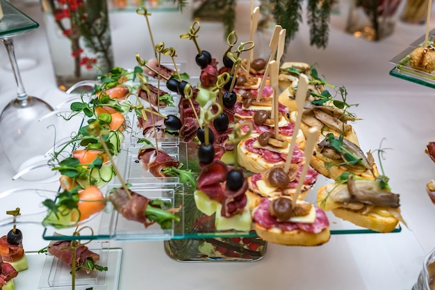 Catering offsite food buffet table with various canapes\
sandwiches hamburgers and snacks