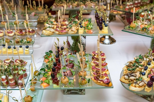 Catering offsite food buffet table with various canapes\
sandwiches hamburgers and snacks