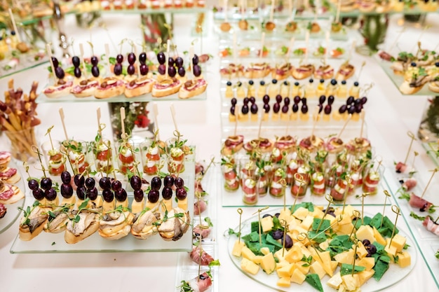 Catering offsite food buffet table with various canapes\
sandwiches hamburgers and snacks