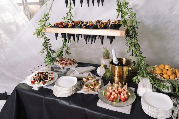 Catering a wedding table with champagne fruits snacks