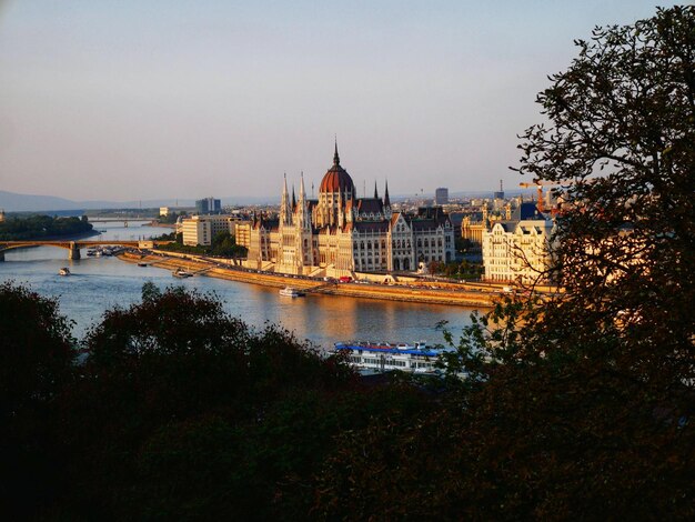 Photo cathedral by river in city against sky