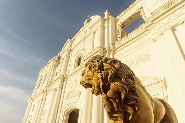 Cathedral outdoors view from down in leon, nicaragua. lion sculpture
