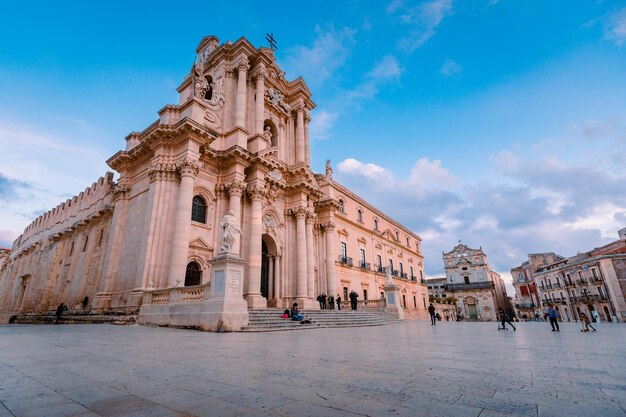 Cathedral square in syracuse with tourists walking