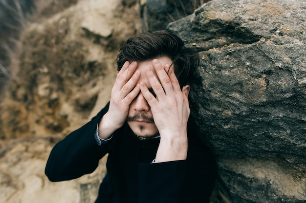 Catholic bearded priest posing outdoors in mountains