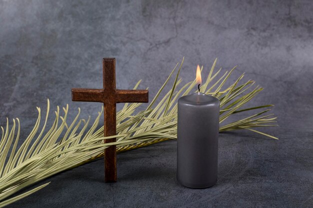 Catholic Cross with palm leaf and burning candle Ash Wednesday Lent season Good Friday Palm Sunday