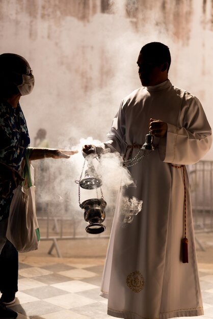 Catholic seminarian waving the candlestick during mass at the church of Santa Luzia in the city of Salvador Bahia