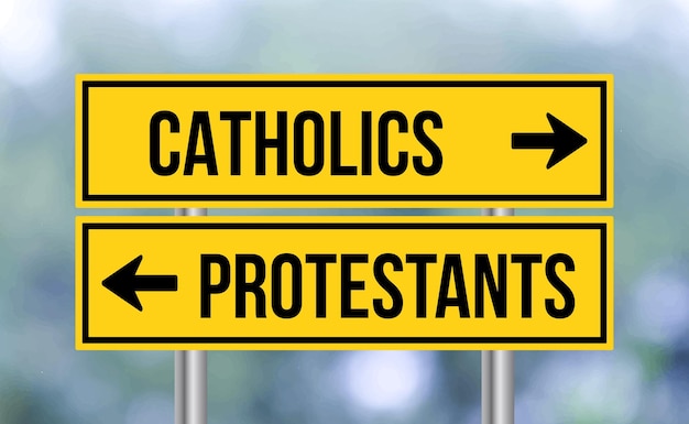 Catholics or protestants road sign on blur background