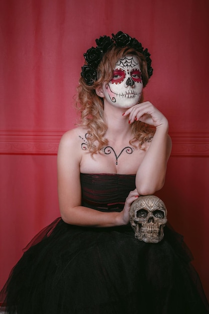 Photo the catrina is a character mexican culture that represent the death and is part of the collective imaginary that refers to the celebration day of the dead sugar skull makeup and flower wreath