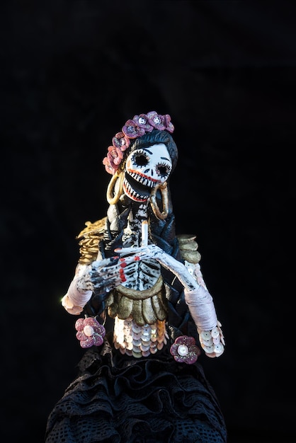 A Catrina or skull with elegant clothing of flowers earrings and jewelry on the day of the dead