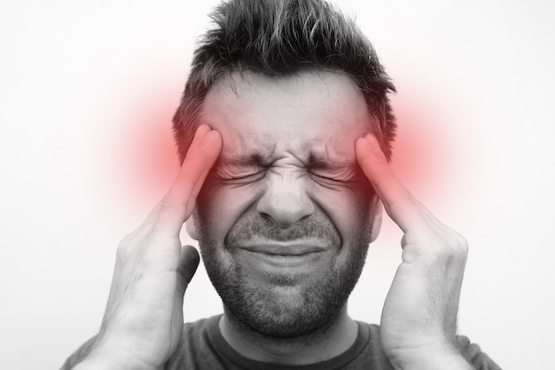 Photo caucasain man with headache on white background close up monochrome photo with red circle