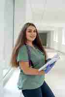 Photo caucasian attractive female nurse ot sudent wear uniform and stethoscope at clinic corridor