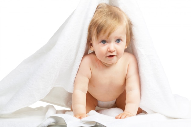 Caucasian baby covered with towel isolated on white background