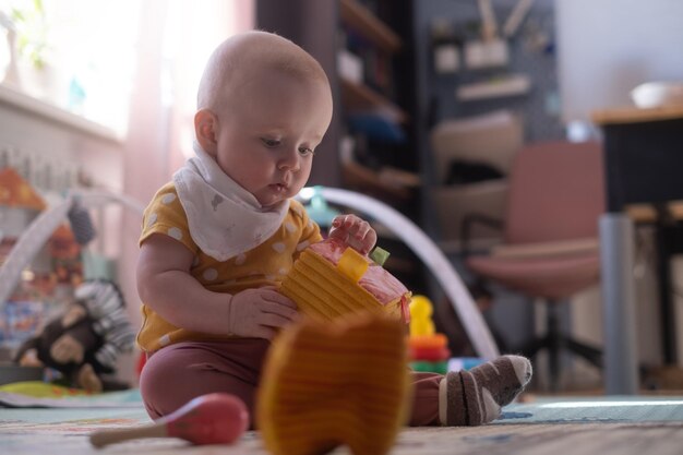 Caucasian baby toddler playing color blocks alone