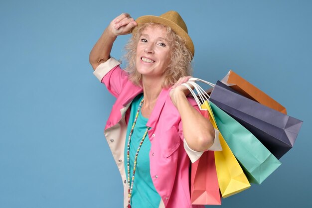 Caucasian beautiful mature woman posing with shopping bags