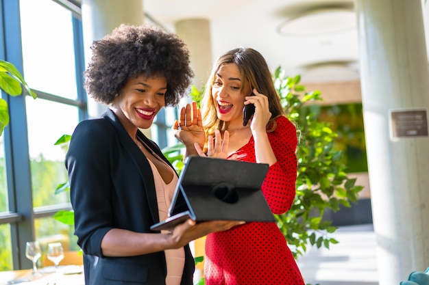 Caucasian blonde and black-skinned girl working together