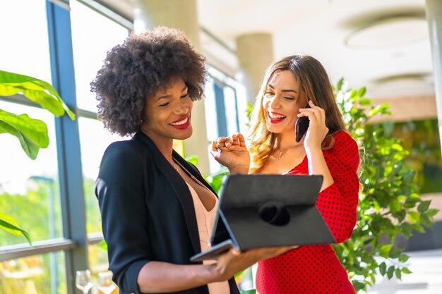 Caucasian blonde and black-skinned girl working together