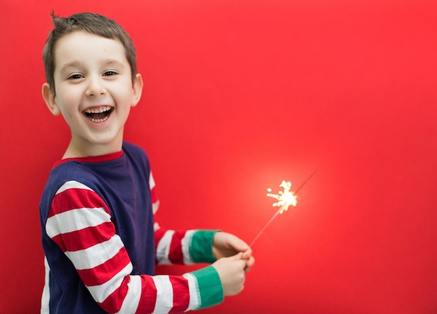 Caucasian boy on red Christmas background