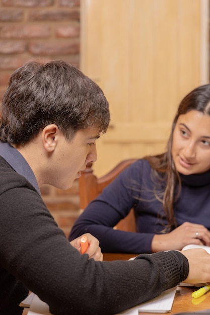 Caucasian boy studying with a latina girl for an exam