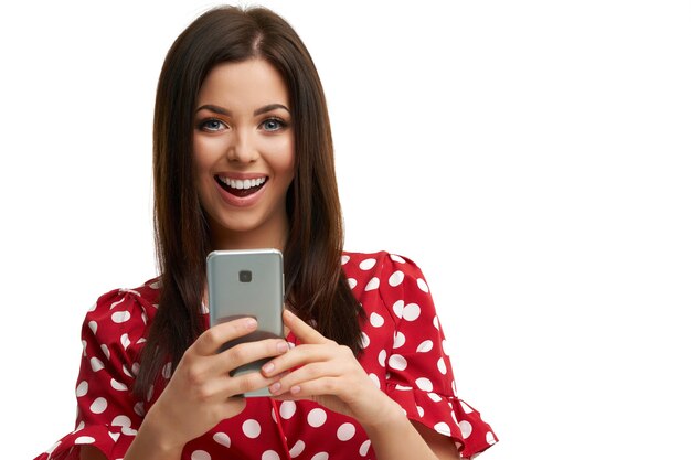 caucasian brunette woman using smartphone isolated over white background