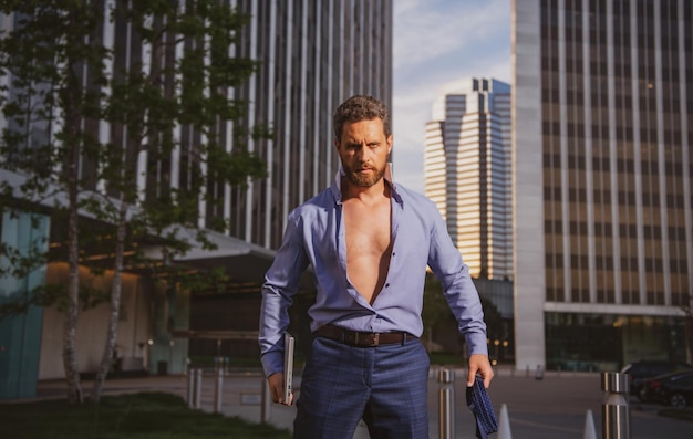 Caucasian business man in suit comes out office concept of end working day Sexy fashion businessman ...