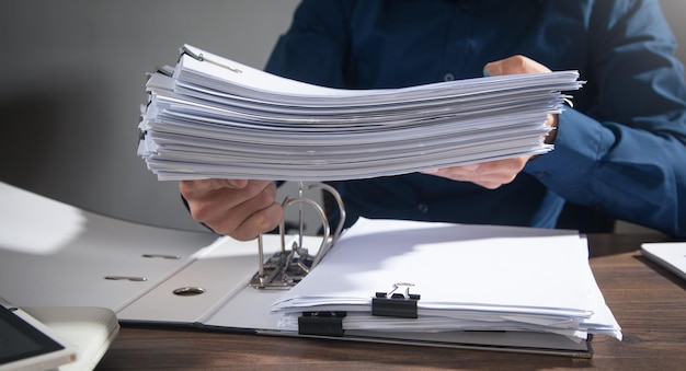 Caucasian businessman holding documents in office