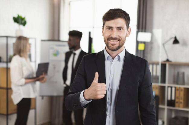 Caucasian businessman posing at boardroom during meeting