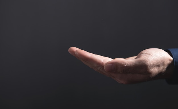 Caucasian businessman showing empty hand.