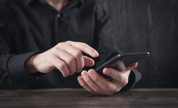 Caucasian businessman using smartphone in office.