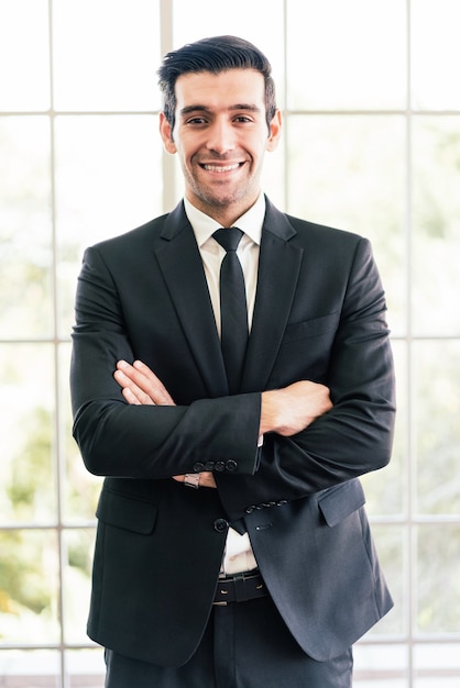 Caucasian confident businessman wearing a suit looking at the camera and smile in good mood