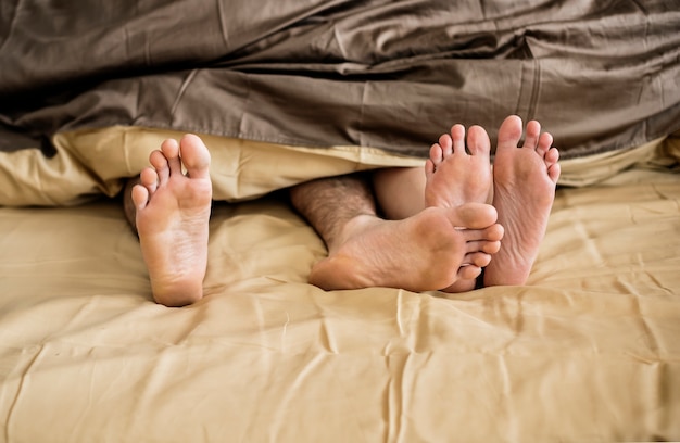 Caucasian couple lying on bed together