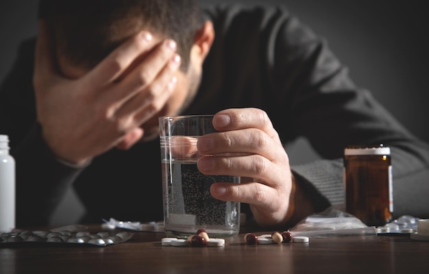 Caucasian depressed man with a pills