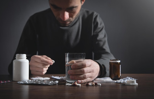 Caucasian depressed man with a pills