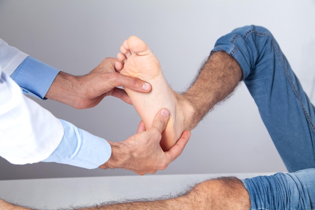 Caucasian doctor examining patient foot