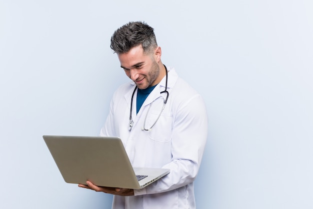 Caucasian doctor man with a laptop