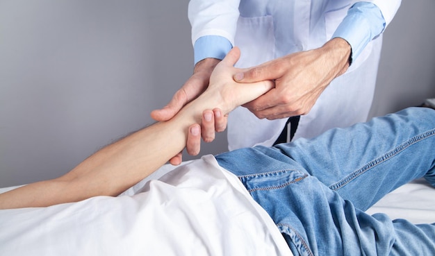 Caucasian doctor massaging patient hand