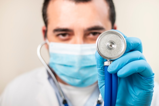 Caucasian doctor with stethoscope and face mask