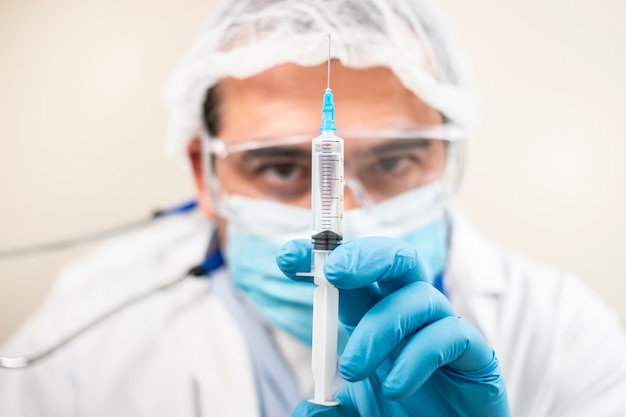 Caucasian doctor with syringe