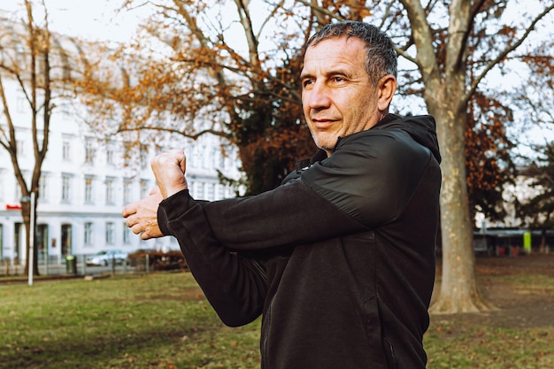 Caucasian elderly man exercising in park