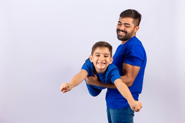 Caucasian father and son on white background smiling and playing father's day concept