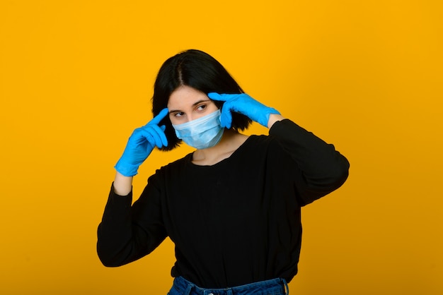 The caucasian girl in blue colored protective face mask.