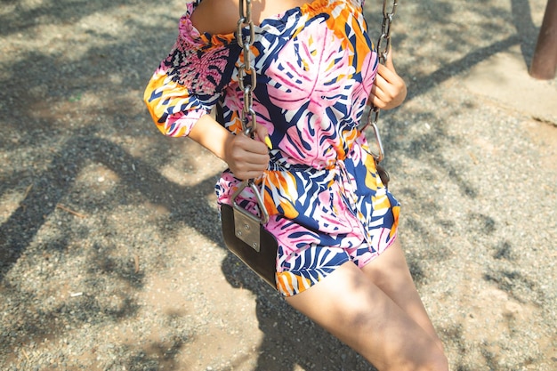 Caucasian girl is swinging on a swing