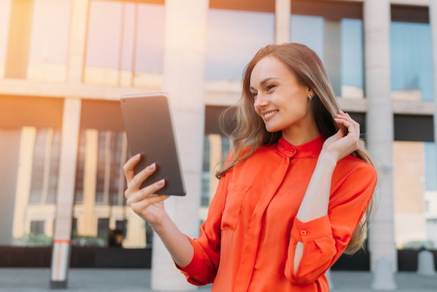 Caucasian girl using tablet and talking on video chat.