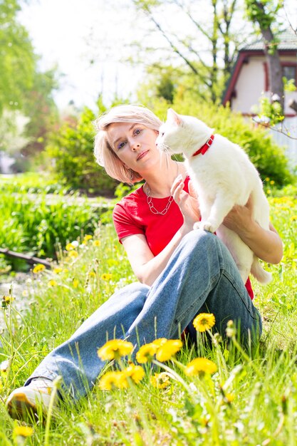 Caucasian girl walking in the park with her cat