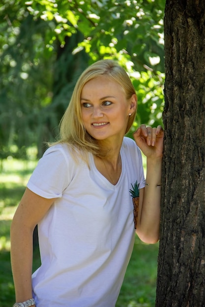 Caucasian girl walks in the park in warm weather outdoors