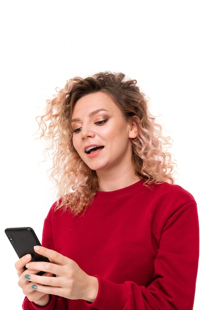 Caucasian girl with curly fair hair chatting with friends and laughing